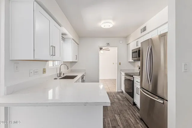 a kitchen with white cabinets and a sink