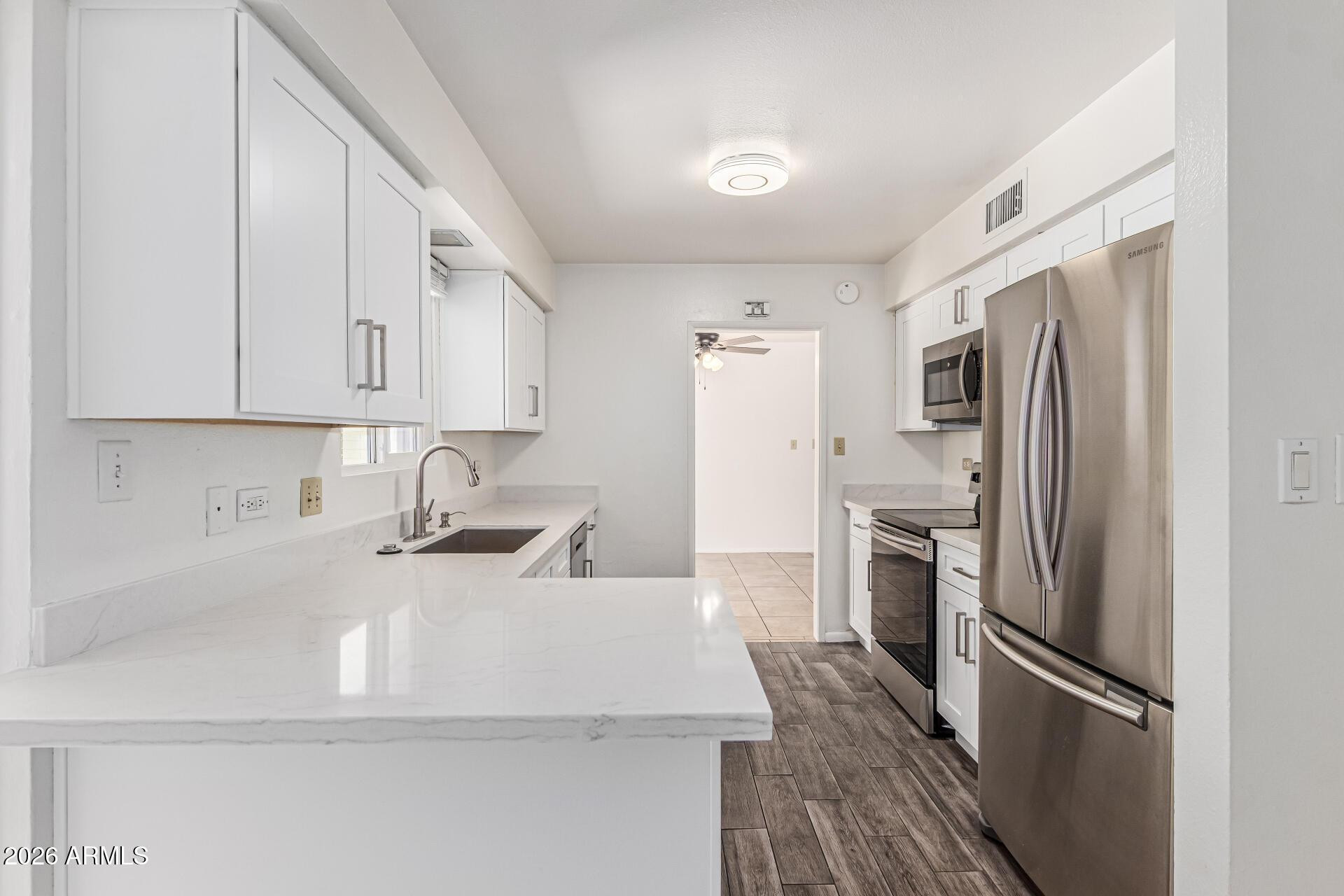 1213 East Riviera Drive Tempe, AZ 85282 - Photo 14 of 28 a kitchen with stainless steel appliances granite countertop a refrigerator sink and stove