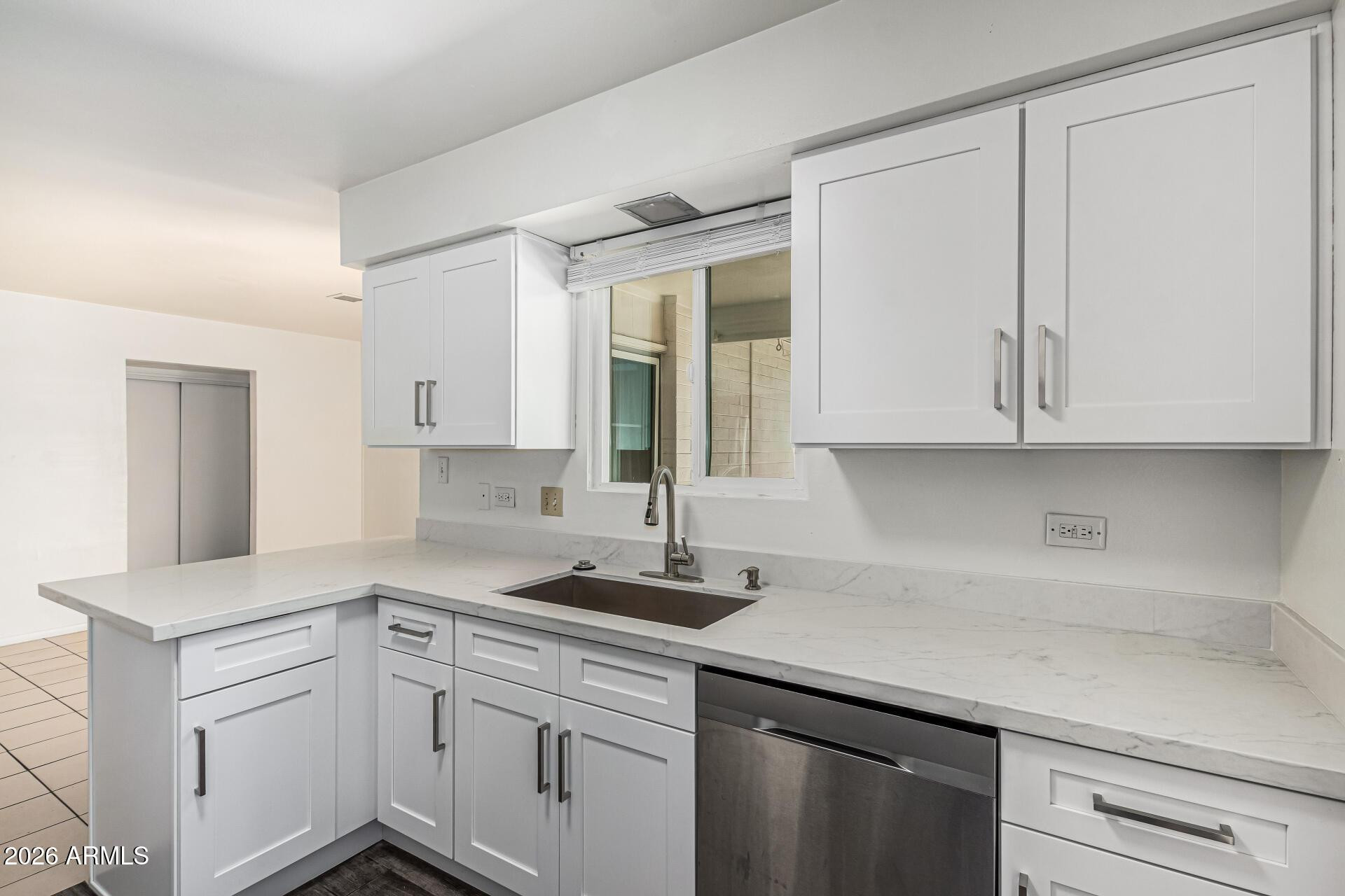 1213 East Riviera Drive Tempe, AZ 85282 - Photo 15 of 28 a kitchen with white cabinets and a sink