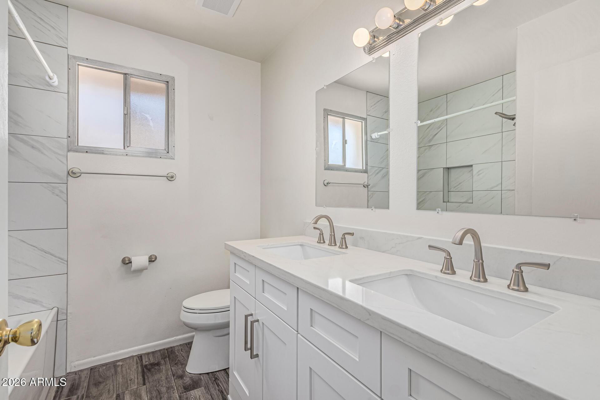 1213 East Riviera Drive Tempe, AZ 85282 - Photo 18 of 28 a bathroom with a toilet a sink and mirror