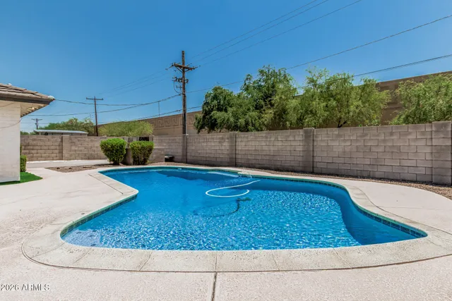 a view of a house with swimming pool and sitting area