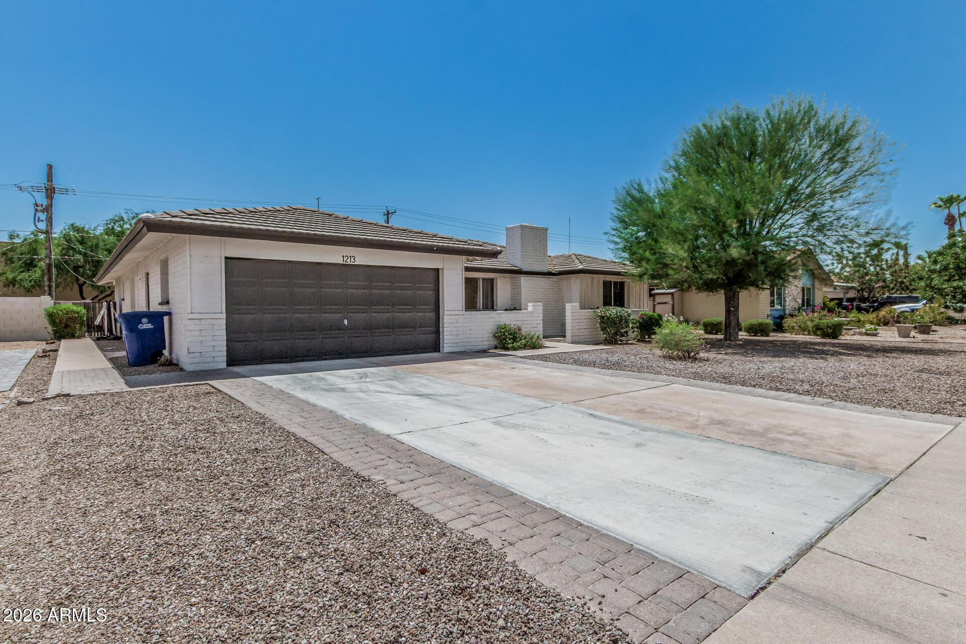 1213 East Riviera Drive Tempe, AZ 85282 - Photo 4 of 28 a front view of a house with a yard and garage
