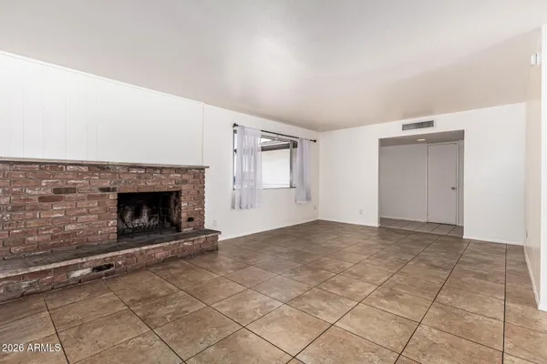 a view of an empty room and fire place