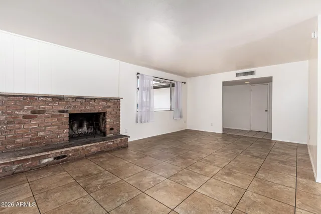 a view of an empty room and fire place