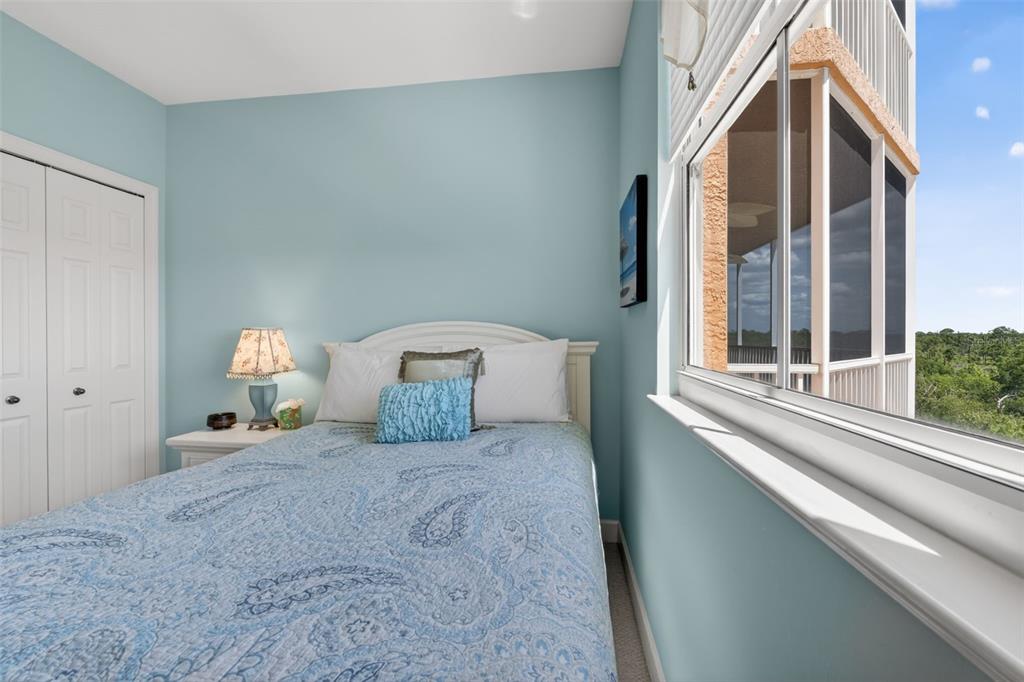3191 Matecumbe Key Road, Unit 202 Punta Gorda, FL 33955 - Photo 25 of 37 a large bedroom with a bed and a large window
