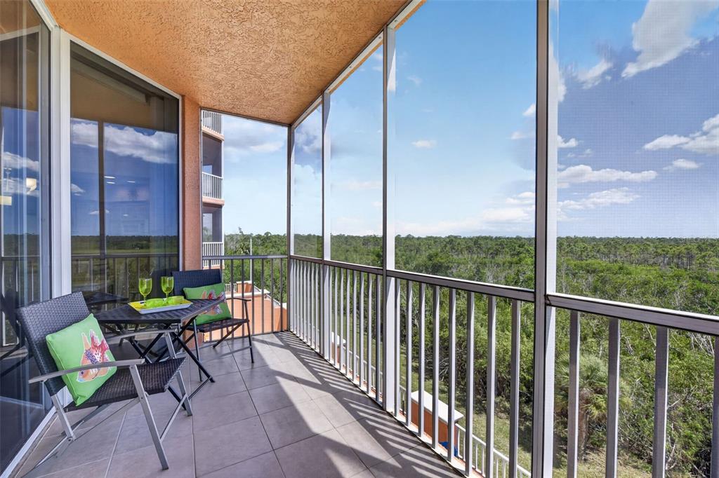 3191 Matecumbe Key Road, Unit 202 Punta Gorda, FL 33955 - Photo 29 of 37 a view of a chairs and table in a balcony