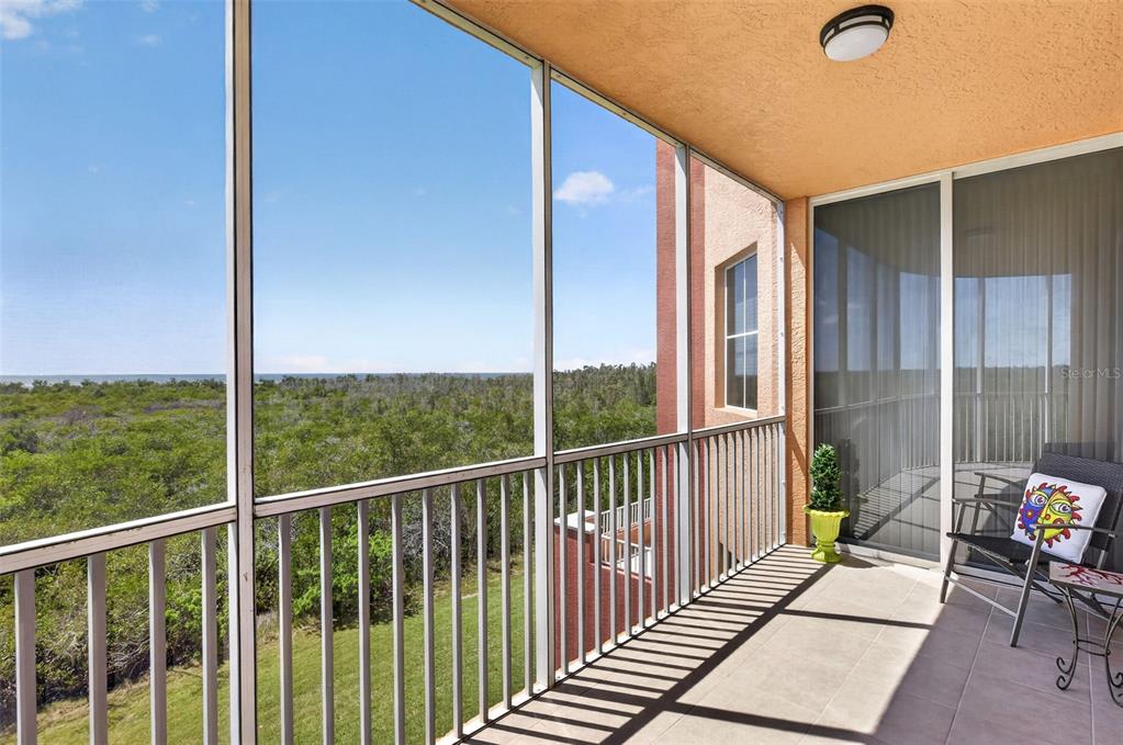 3191 Matecumbe Key Road, Unit 202 Punta Gorda, FL 33955 - Photo 32 of 37 a view of a balcony with chair and wooden floor