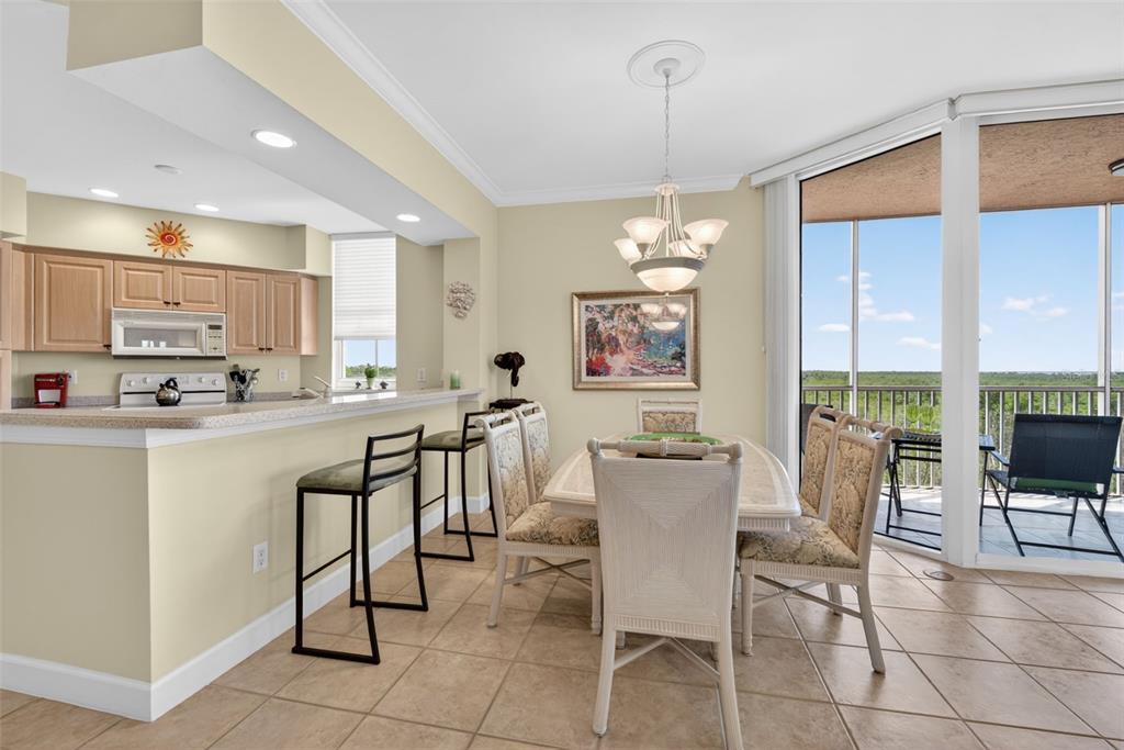 3191 Matecumbe Key Road, Unit 202 Punta Gorda, FL 33955 - Photo 4 of 37 a view of kitchen with dining area and chandelier