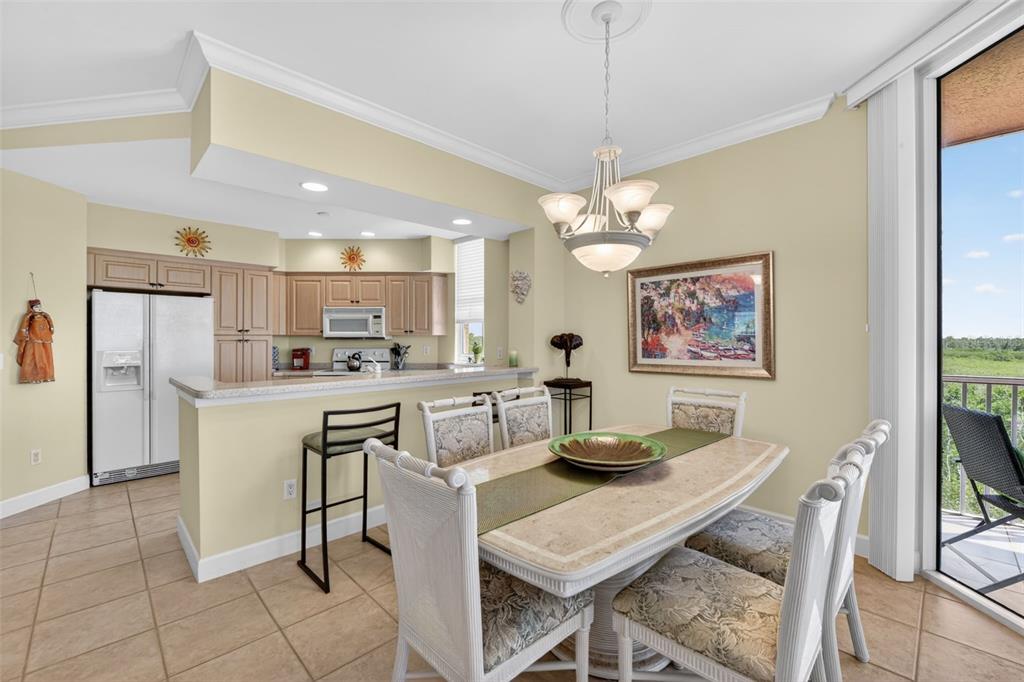 3191 Matecumbe Key Road, Unit 202 Punta Gorda, FL 33955 - Photo 7 of 37 a view of a dining room with furniture and chandelier