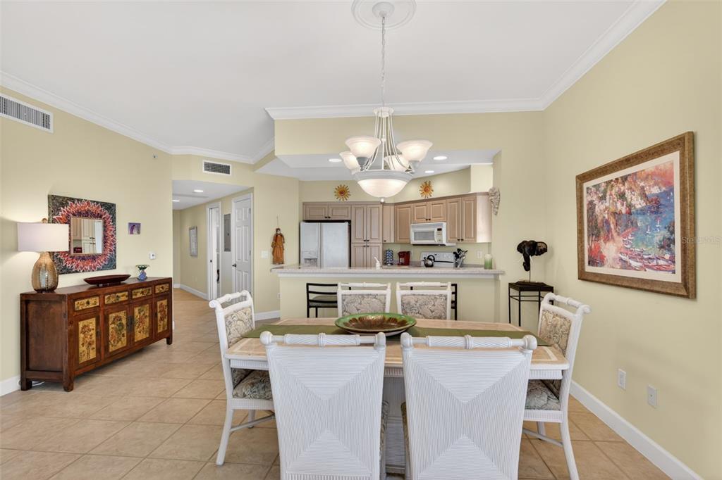 3191 Matecumbe Key Road, Unit 202 Punta Gorda, FL 33955 - Photo 8 of 37 a view of a dining room with furniture and a chandelier