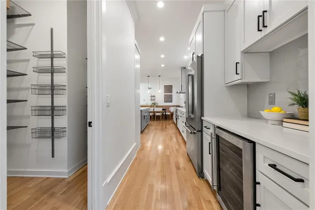 a kitchen with stainless steel appliances granite countertop a refrigerator and a sink