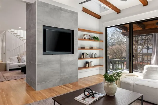 a living room with furniture potted plant and a flat screen tv