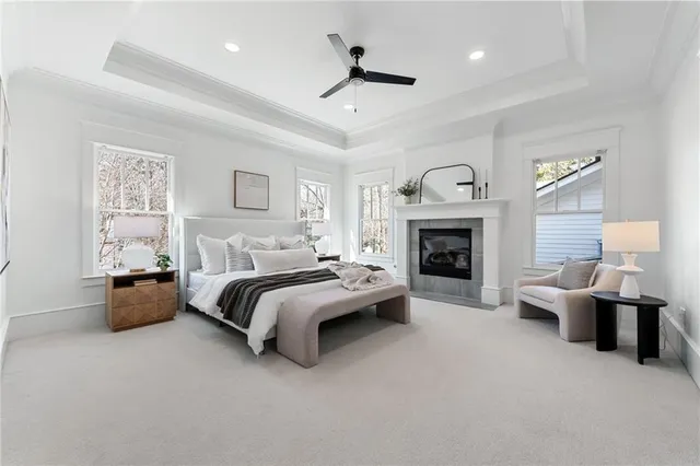 a spacious bedroom with a large bed and a fireplace