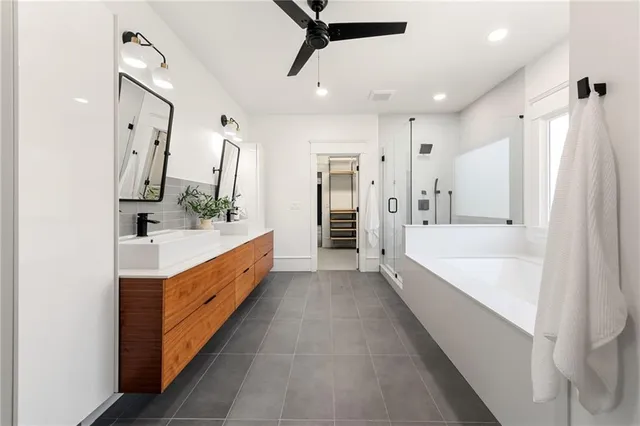 a bathroom with a double vanity sink a bathtub and shower