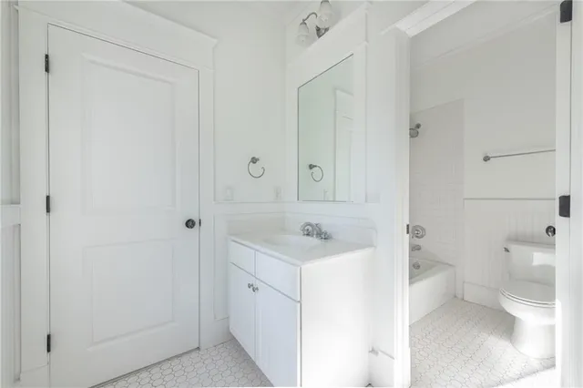 a bathroom with a sink a toilet and a shower