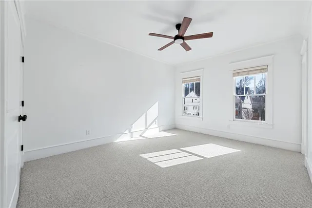 a view of a livingroom with a ceiling fan and window