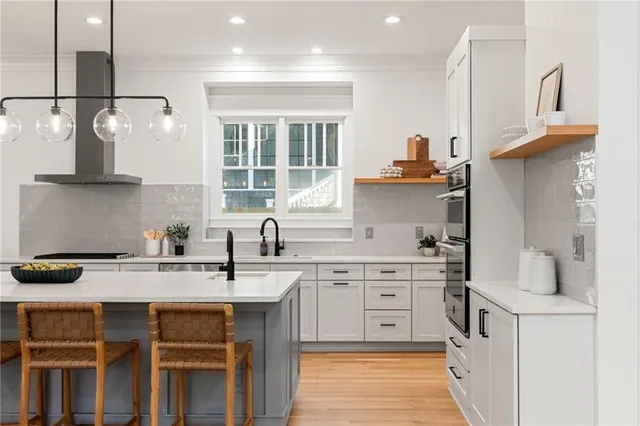 a kitchen with a sink stove and cabinets