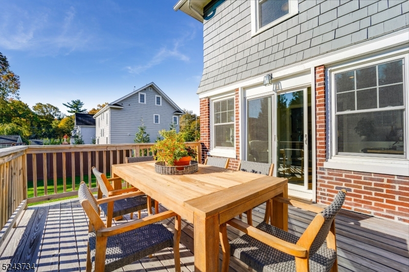 2 Loantaka Way Madison, NJ 07940 - Photo 22 of 50 a view of a patio with table and chairs with wooden floor and fence