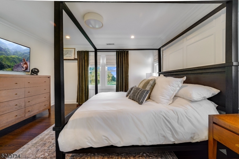 2 Loantaka Way Madison, NJ 07940 - Photo 24 of 50 a bedroom with a large bed and a flat tv screen on dresser