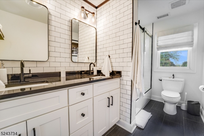 2 Loantaka Way Madison, NJ 07940 - Photo 26 of 50 a bathroom with a toilet sink and mirror