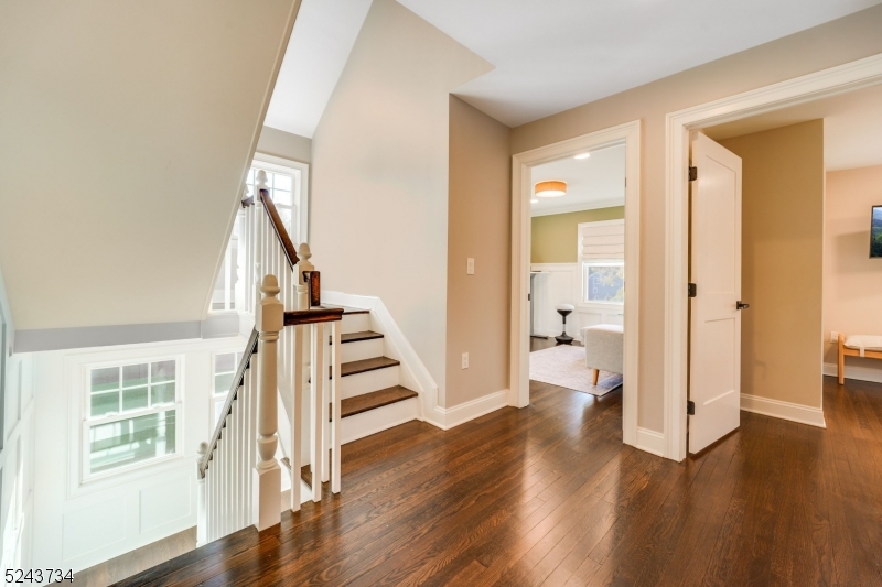 2 Loantaka Way Madison, NJ 07940 - Photo 31 of 50 a view of a hallway with wooden floor staircase and a living room