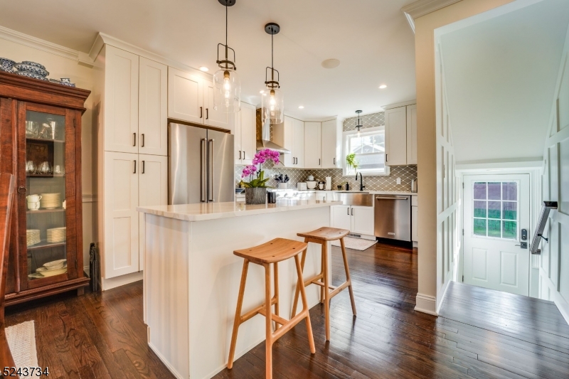 2 Loantaka Way Madison, NJ 07940 - Photo 4 of 50 a kitchen with stainless steel appliances granite countertop a refrigerator a oven a sink dishwasher and white cabinets with wooden floor
