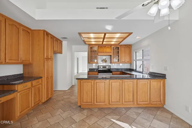 a kitchen with stainless steel appliances granite countertop a refrigerator and microwave