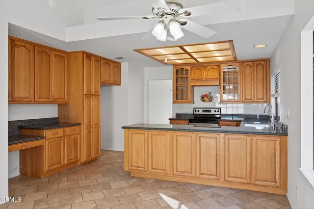 a kitchen with stainless steel appliances granite countertop a stove a sink and a refrigerator
