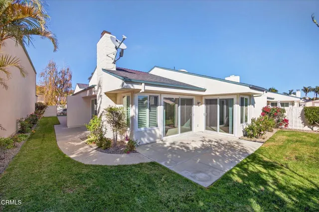 a front view of a house with a yard table and chairs