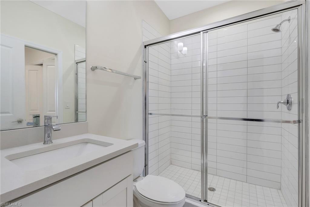 7540 Carnegie Way Naples, FL 34119 - Photo 14 of 40 a bathroom with a sink toilet and shower