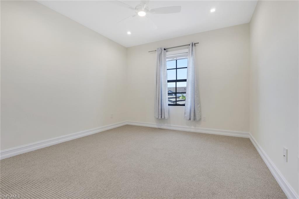 7540 Carnegie Way Naples, FL 34119 - Photo 16 of 40 an empty room with windows