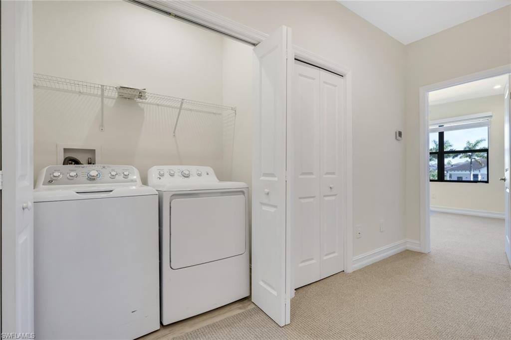 7540 Carnegie Way Naples, FL 34119 - Photo 17 of 40 a utility room with dryer and washer