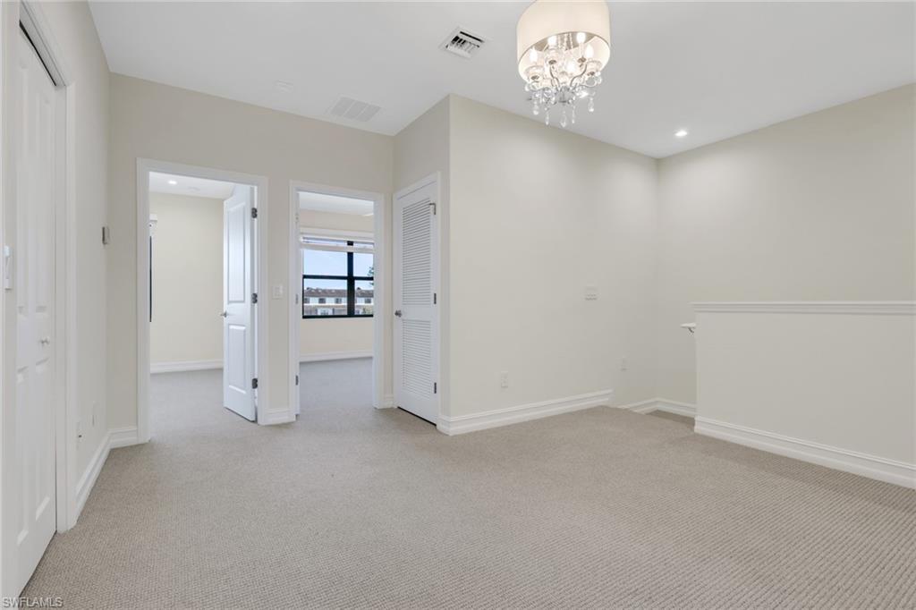 7540 Carnegie Way Naples, FL 34119 - Photo 18 of 40 wooden floor in an empty room