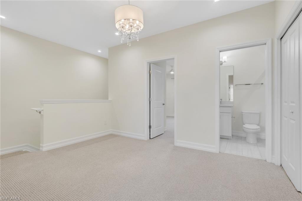 7540 Carnegie Way Naples, FL 34119 - Photo 19 of 40 wooden floor in an empty room