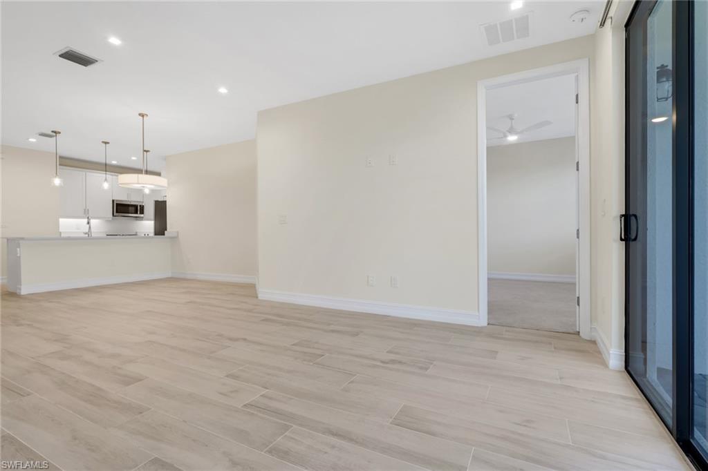 7540 Carnegie Way Naples, FL 34119 - Photo 30 of 40 a view of a kitchen with a sink and a refrigerator