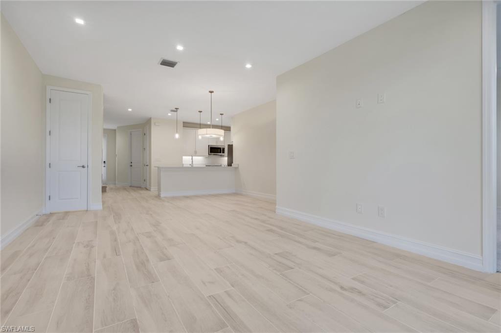 7540 Carnegie Way Naples, FL 34119 - Photo 31 of 40 a view of a kitchen with a sink and a refrigerator
