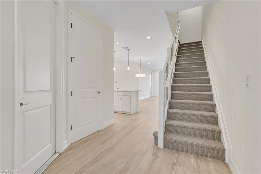 7540 Carnegie Way Naples, FL 34119 - Photo 39 of 40 a view of entryway and hall with wooden floor