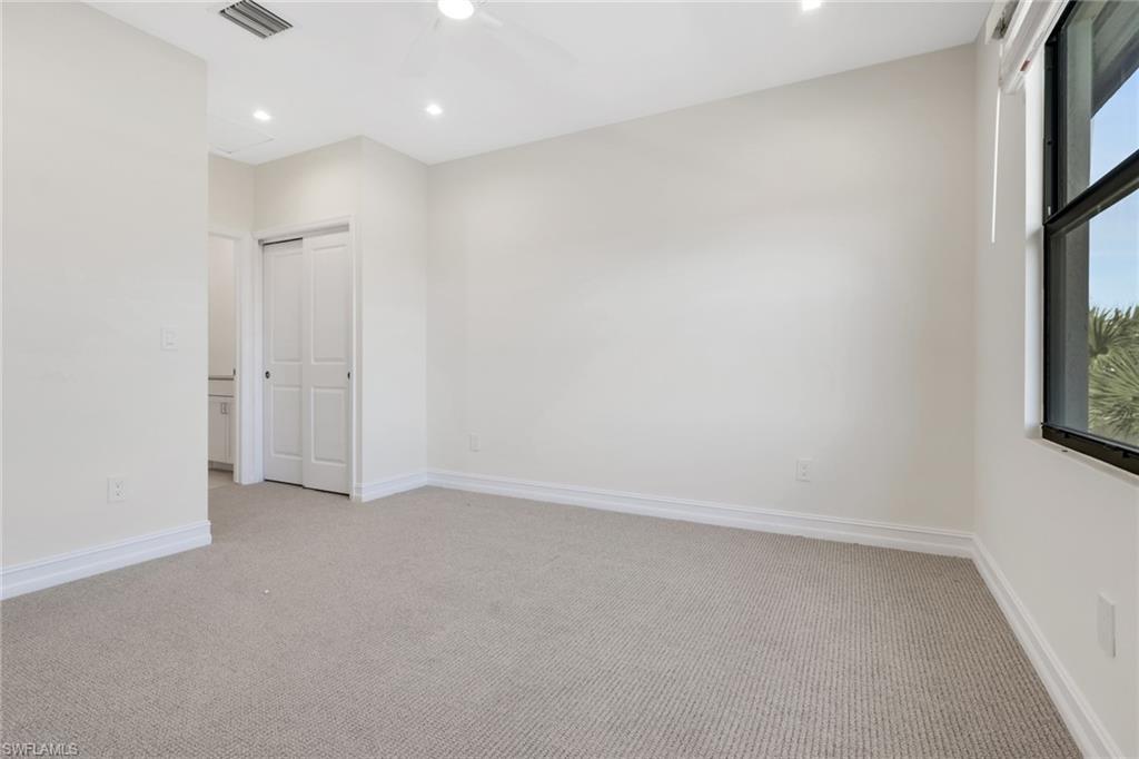 7540 Carnegie Way Naples, FL 34119 - Photo 10 of 40 an empty room with windows and closet