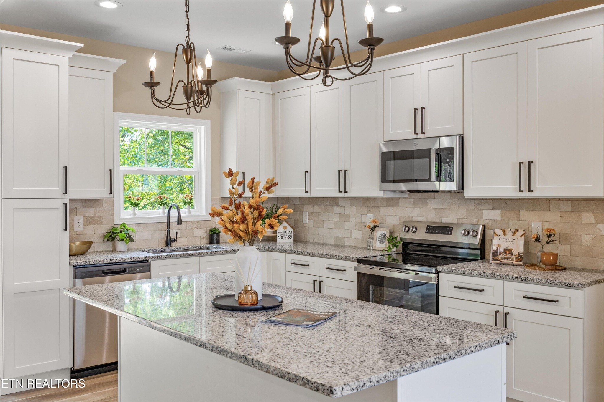 210 Daniel Morris Point Clinton, TN 37716 - Photo 11 of 45 a kitchen with stainless steel appliances granite countertop a sink a stove and a counter top space
