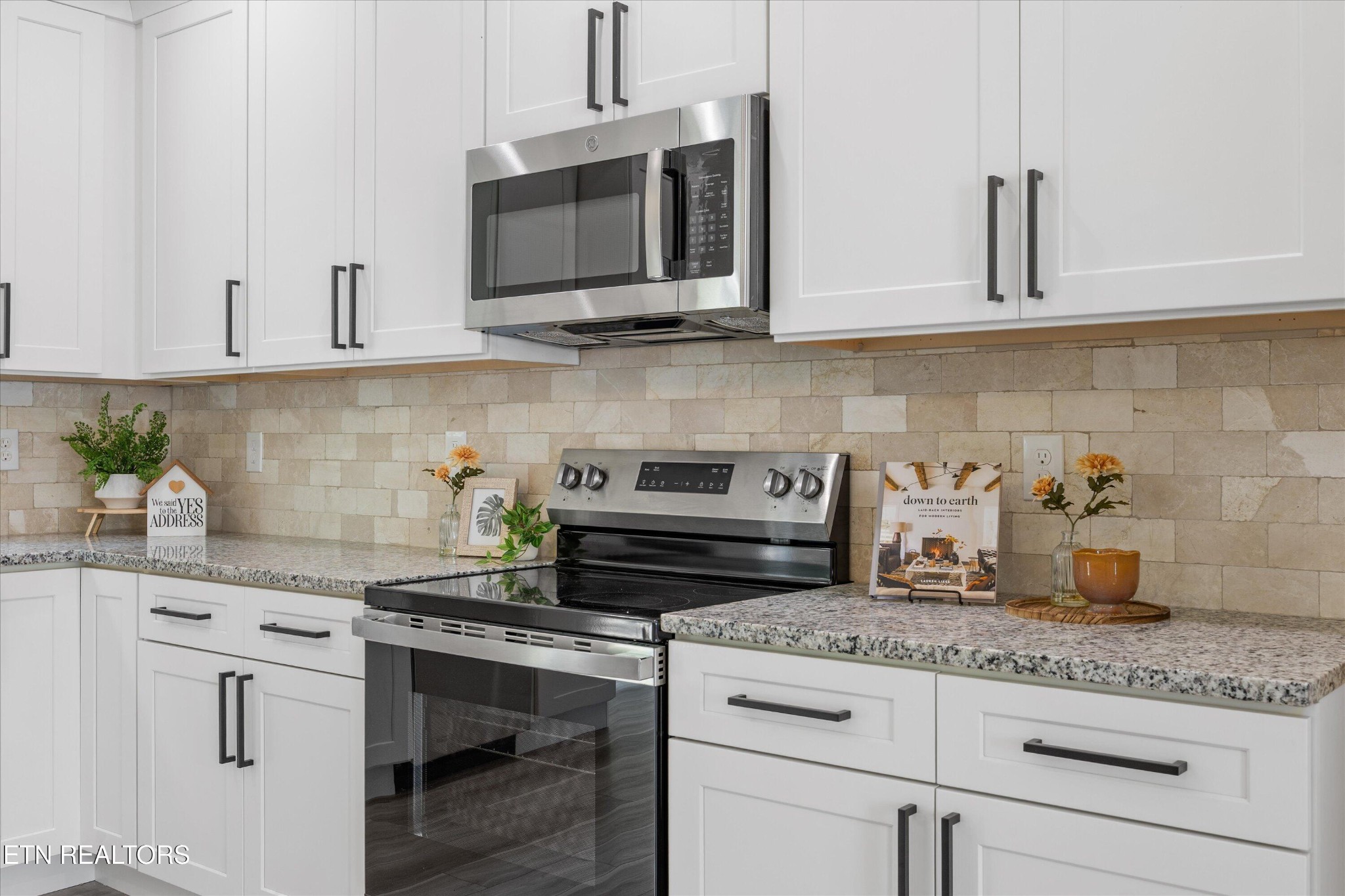 210 Daniel Morris Point Clinton, TN 37716 - Photo 14 of 45 a kitchen with granite countertop white cabinets stainless steel appliances and sink