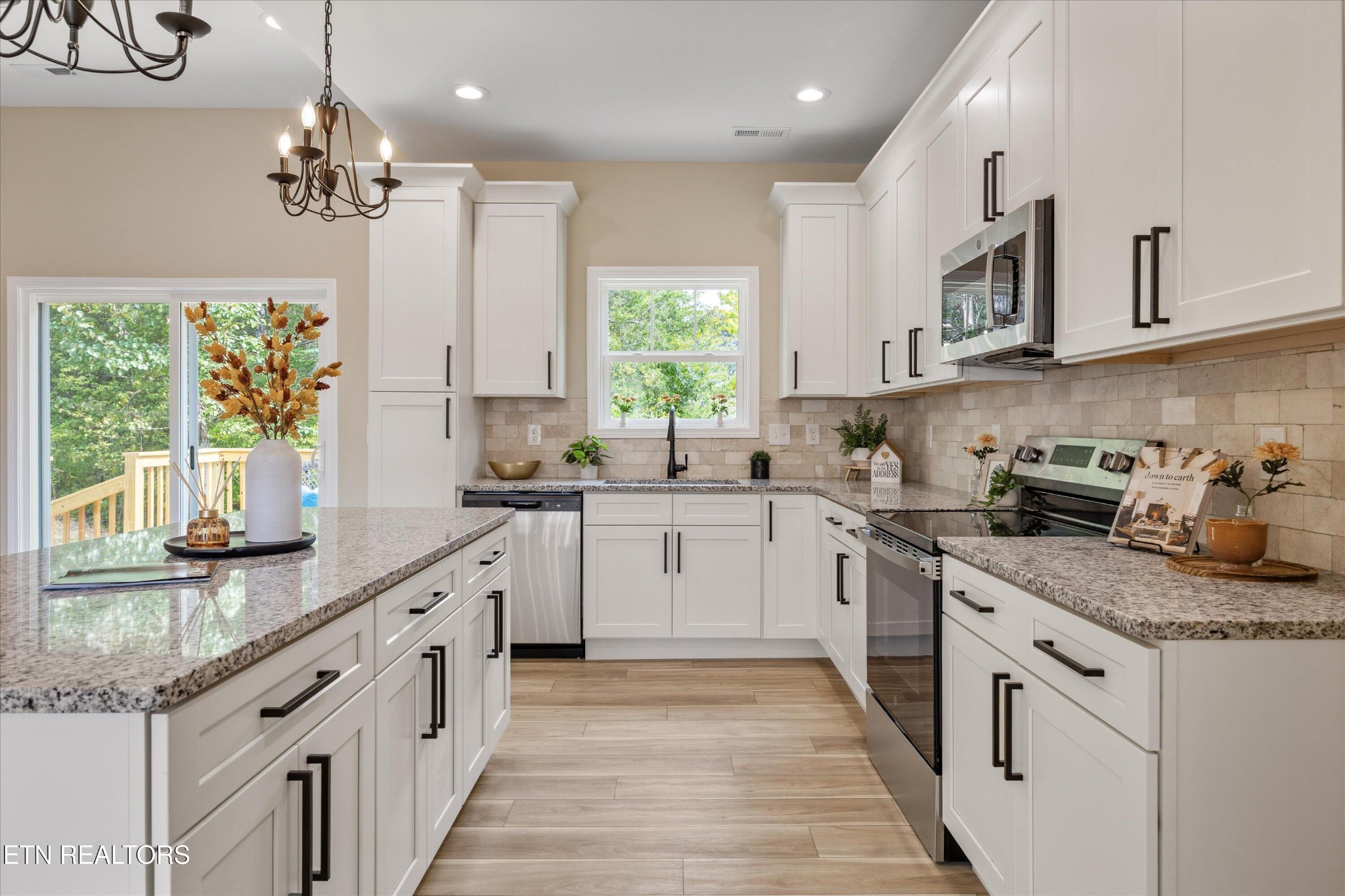 210 Daniel Morris Point Clinton, TN 37716 - Photo 15 of 45 a kitchen with granite countertop stainless steel appliances a sink window and cabinets