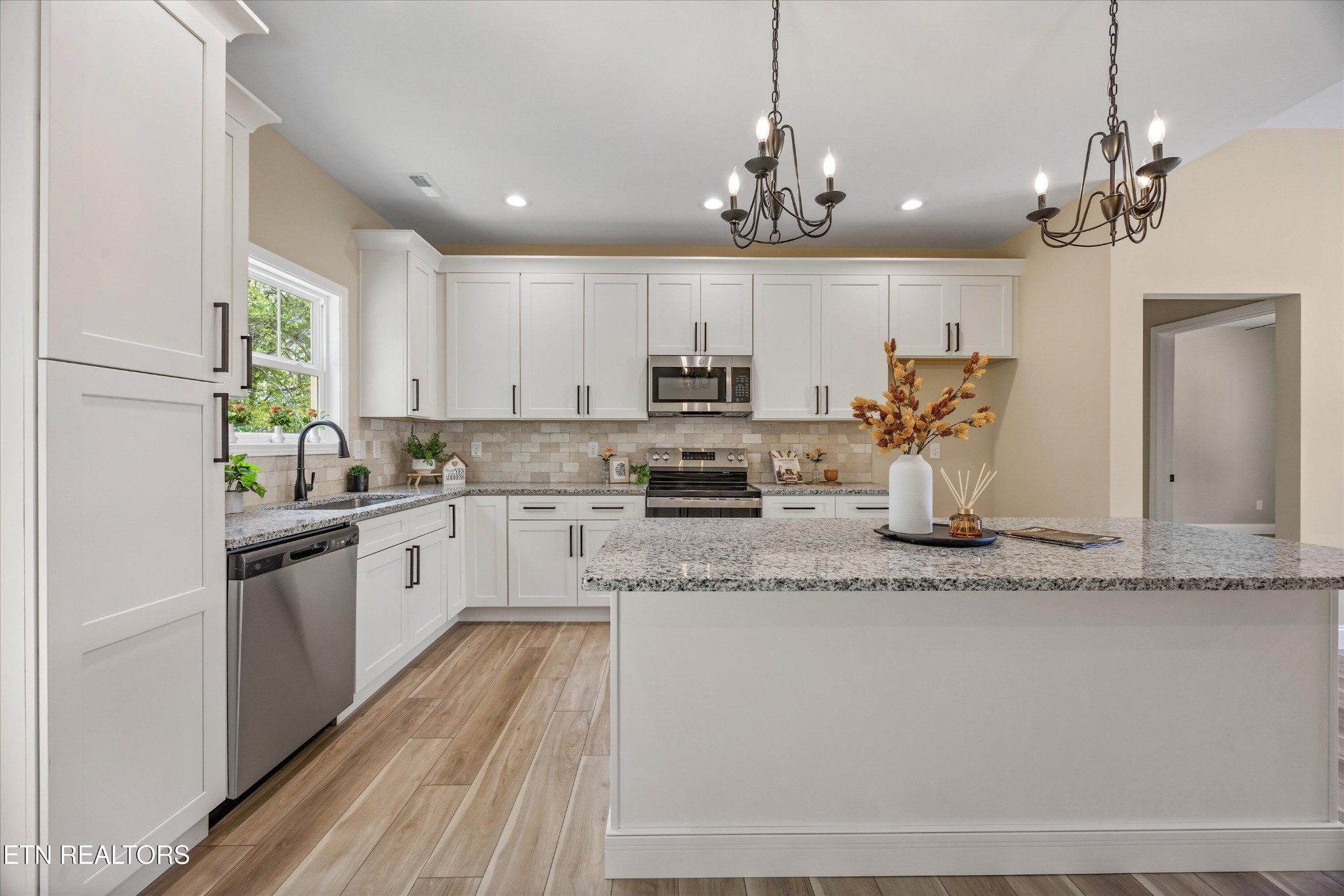 210 Daniel Morris Point Clinton, TN 37716 - Photo 16 of 45 a kitchen with kitchen island granite countertop stainless steel appliances a sink stove and cabinets