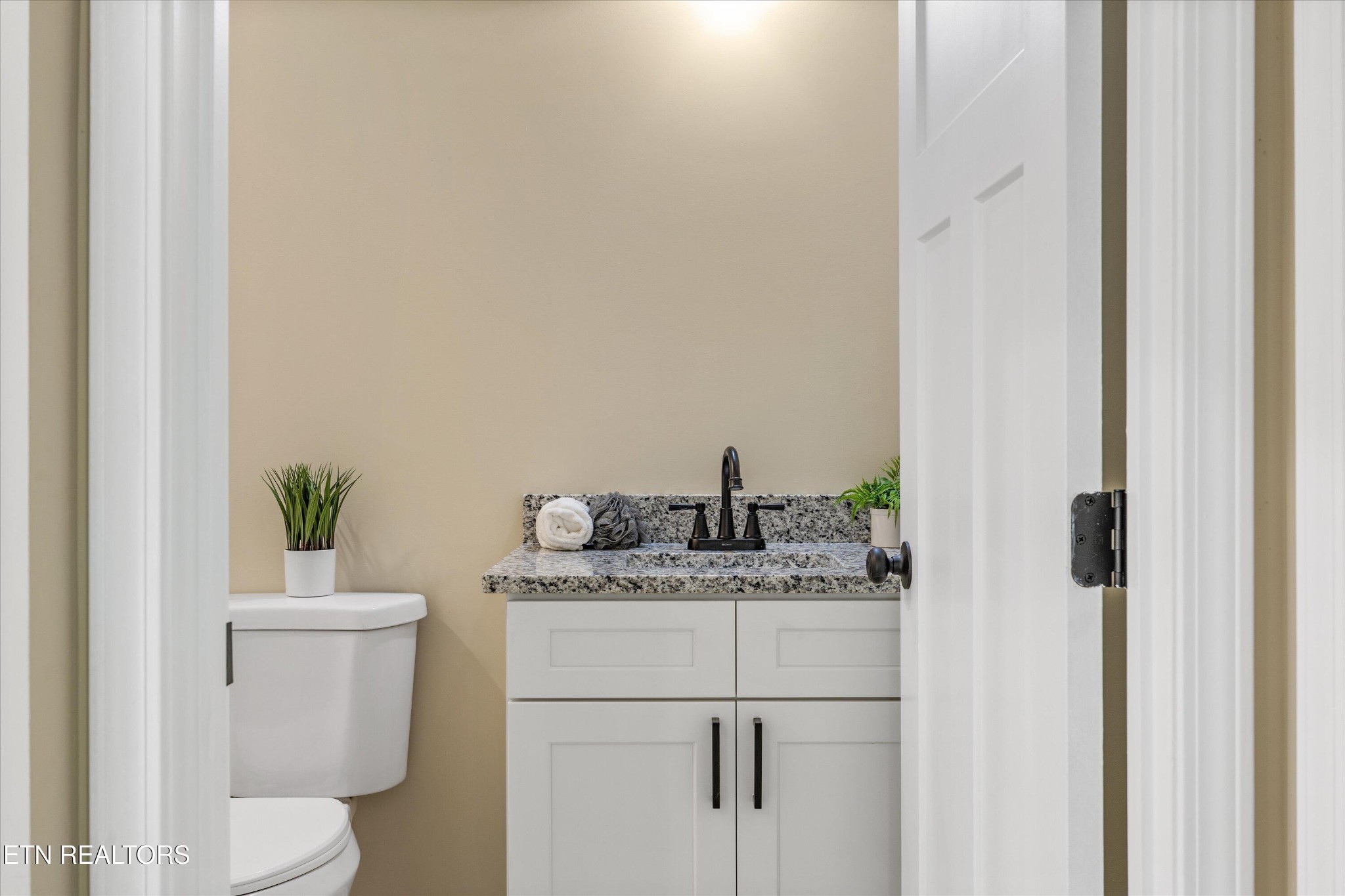210 Daniel Morris Point Clinton, TN 37716 - Photo 20 of 45 a bathroom with a granite countertop sink toilet and a mirror