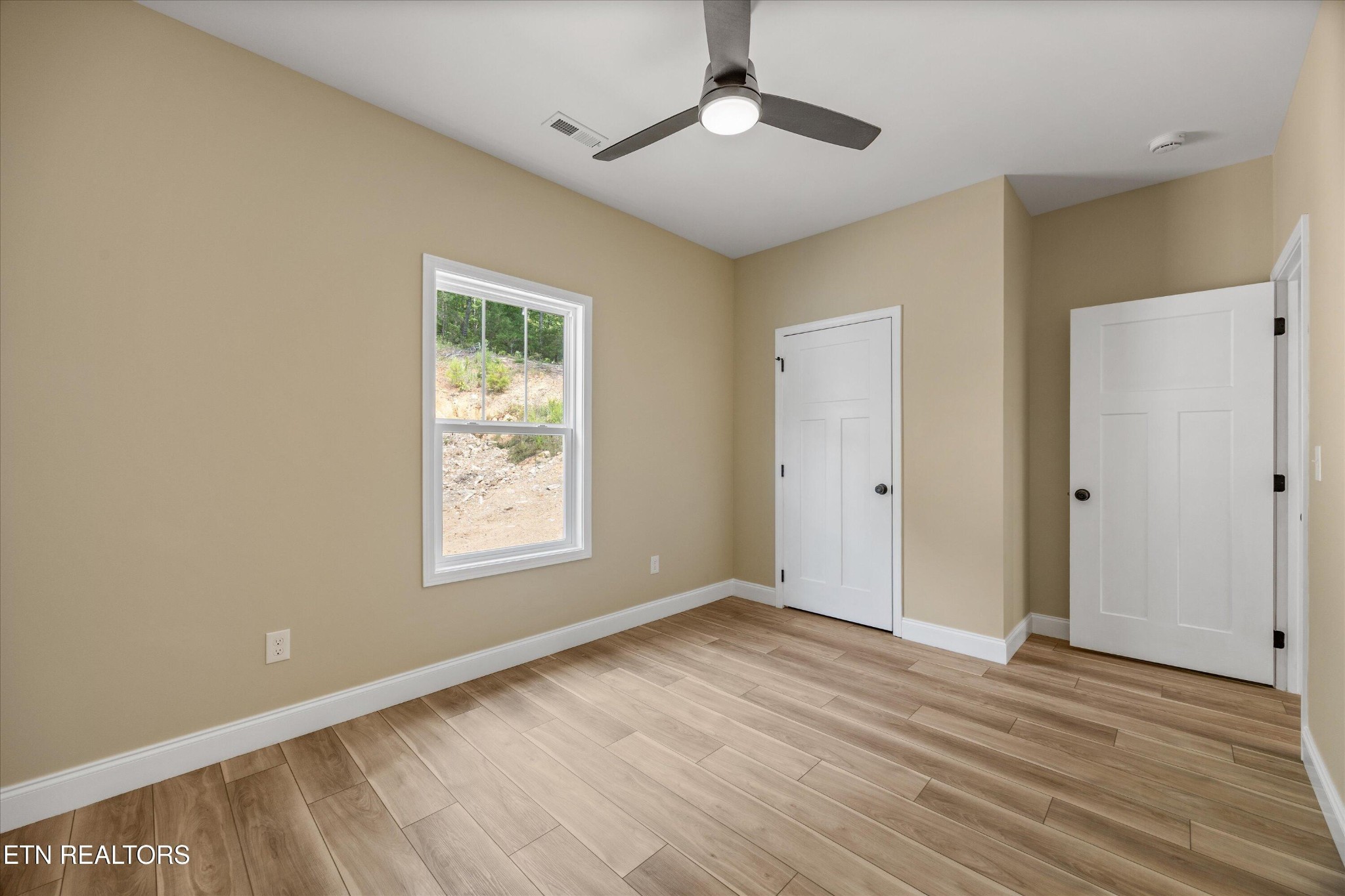 210 Daniel Morris Point Clinton, TN 37716 - Photo 22 of 45 a view of an empty room with wooden floor and a window