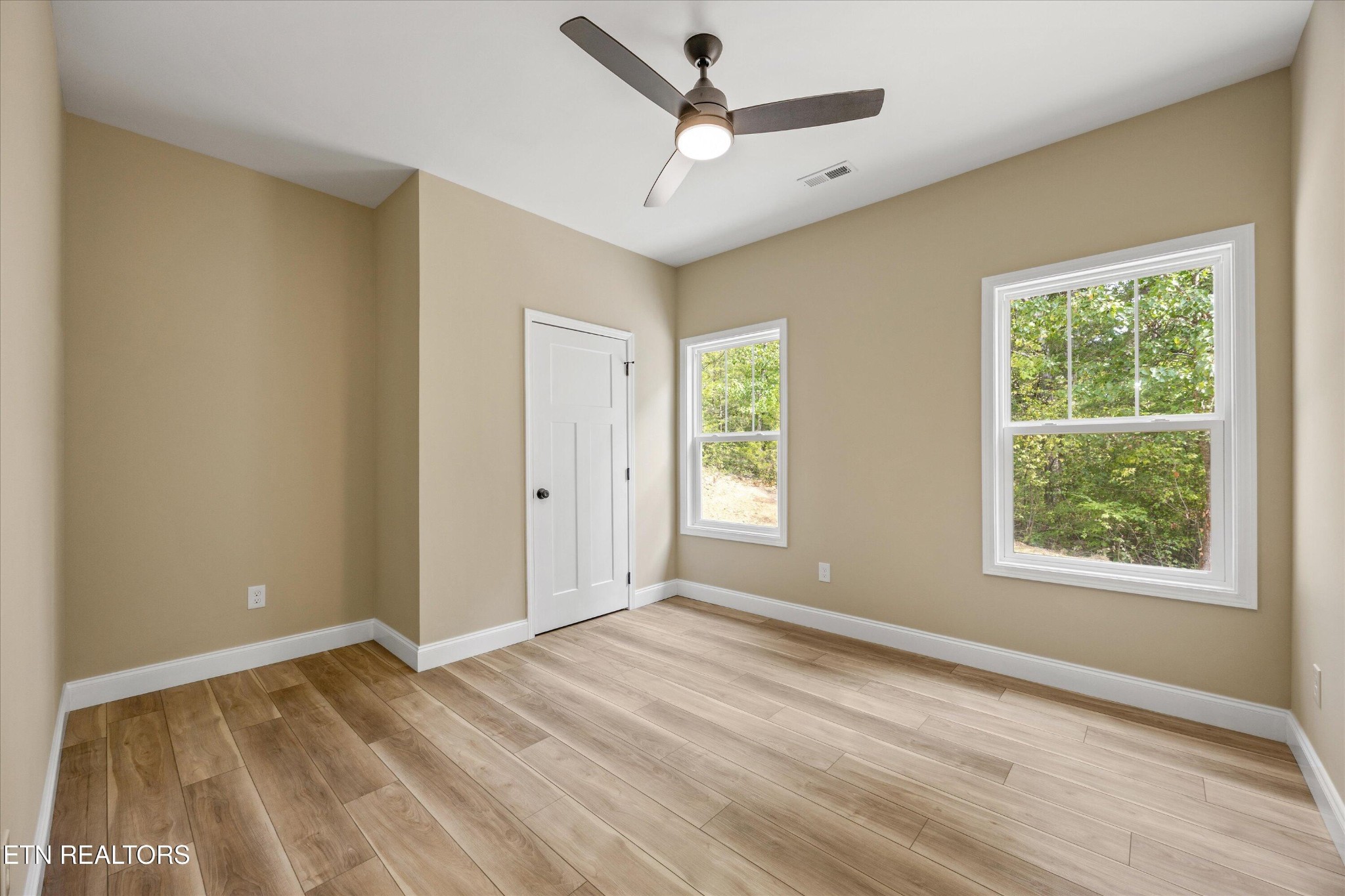 210 Daniel Morris Point Clinton, TN 37716 - Photo 23 of 45 a view of empty room with wooden floor and fan