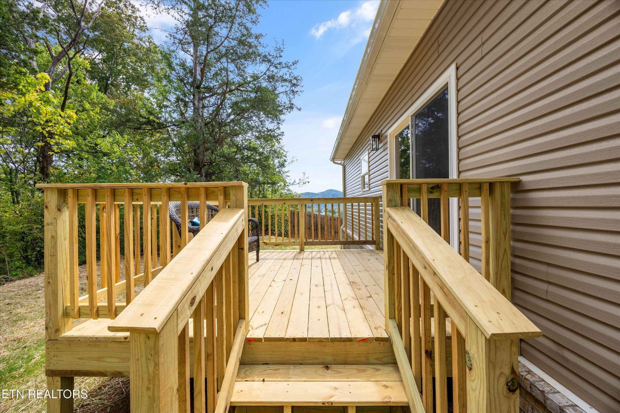 210 Daniel Morris Point Clinton, TN 37716 - Photo 32 of 45 a view of balcony with wooden floor and fence and floor to ceiling window