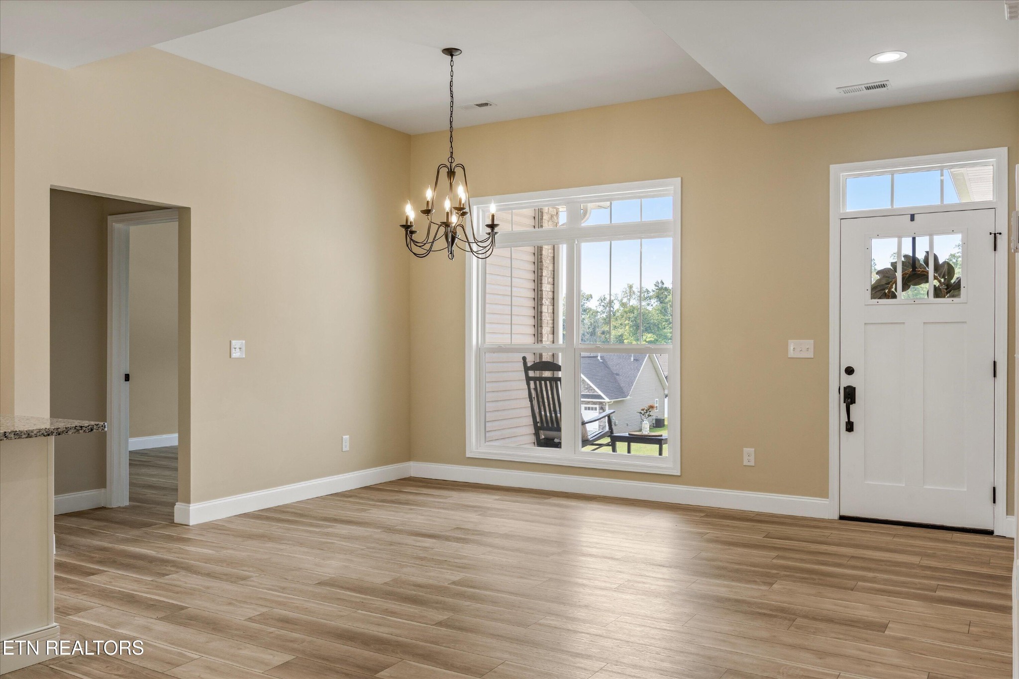 210 Daniel Morris Point Clinton, TN 37716 - Photo 4 of 45 an empty room with wooden floor mirror and windows