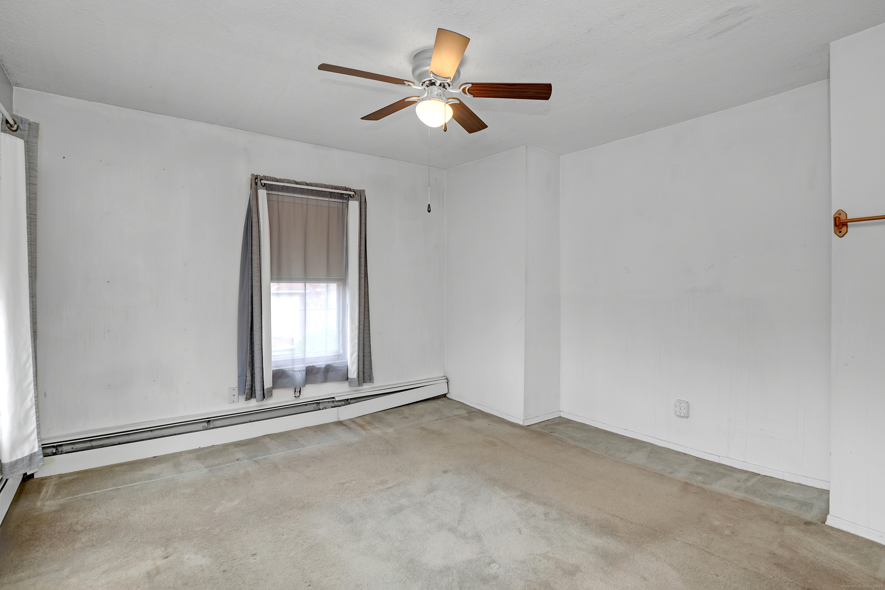 22 Lewis Street Naugatuck, CT 06770 - Photo 29 of 31 an empty room with ceiling fan and window