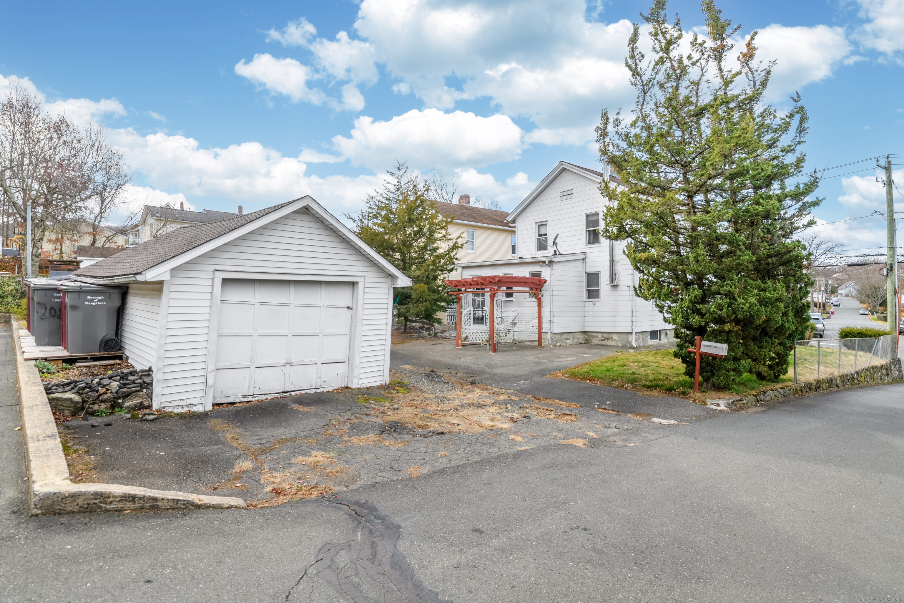 22 Lewis Street Naugatuck, CT 06770 - Photo 4 of 31 a view of a house with a yard and garage