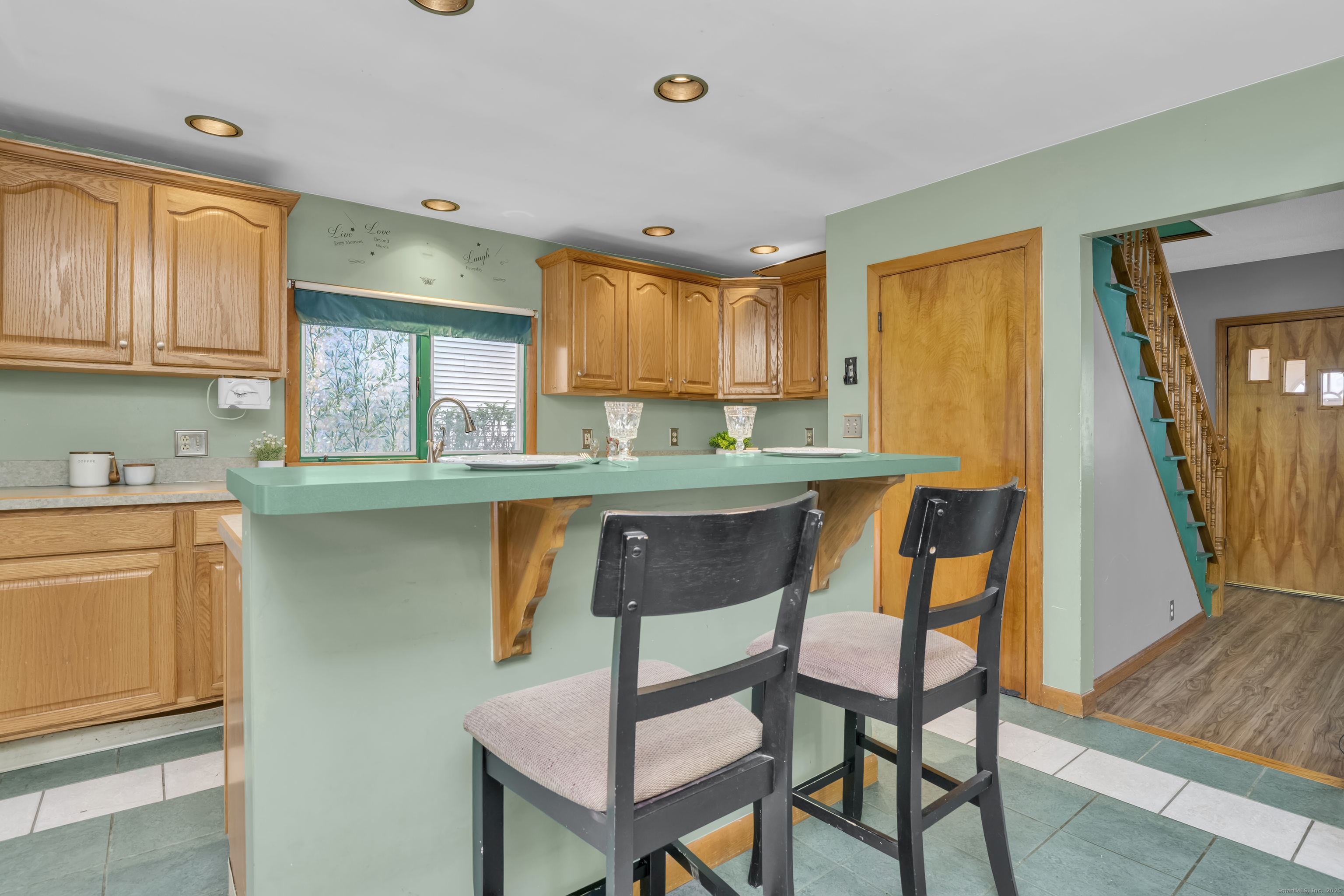 22 Lewis Street Naugatuck, CT 06770 - Photo 8 of 31 a kitchen with stainless steel appliances granite countertop a table chairs sink and cabinets